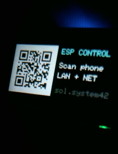 Close camera crop of the QR code displayed on the T-Dongle screen